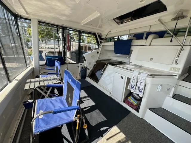 Slide: The Image of 1998 Silverton 372 Motor Yacht interior with blue chairs and white cabinetry. - 17