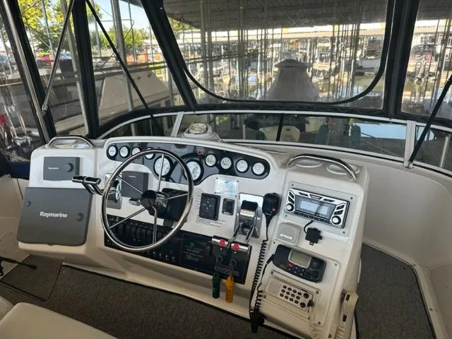 Slide: The Image of 1998 Silverton 372 Motor Yacht helm with navigation instruments and controls. - 18