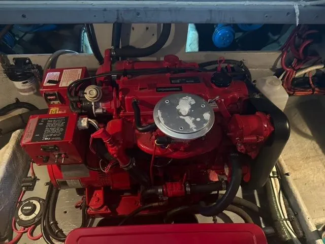 Slide: The Image of Engine compartment of a 1998 Silverton 372 Motor Yacht, featuring a red engine. - 19