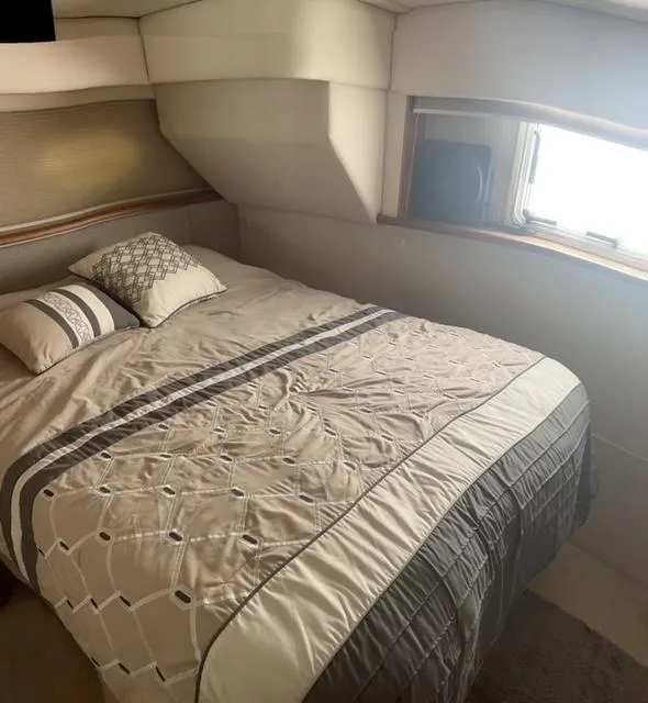 Slide: The Image of Interior of 1998 Silverton 372 Motor Yacht with cozy bed and window. - 28