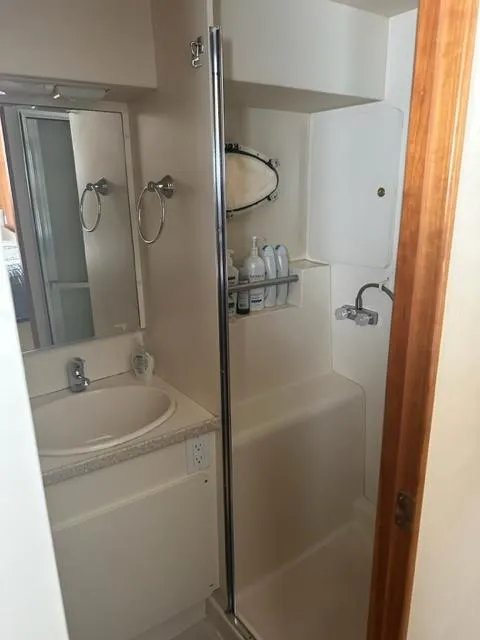 Slide: The Image of 1998 Silverton 372 Motor Yacht bathroom with shower, sink, and mirror. - 31