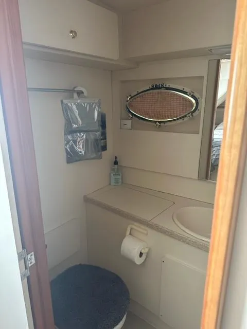 Slide: The Image of 1998 Silverton 372 Motor Yacht bathroom with sink, mirror, and storage. - 32
