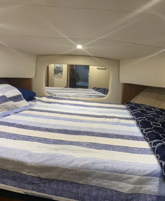Slide: The Image of Interior cabin of 1998 Silverton 372 Motor Yacht with striped bedding. - 34
