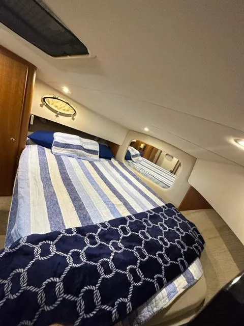 Slide: The Image of Interior cabin of 1998 Silverton 372 Motor Yacht with striped bedding. - 36