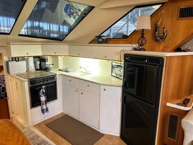 Slide: The Image of Interior of 1998 Silverton 372 Motor Yacht kitchen with stove, fridge, and cabinets. - 43