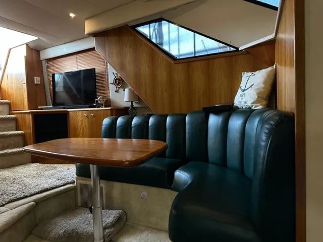 Slide: The Image of Interior of 1998 Silverton 372 Motor Yacht with leather seating and wooden accents. - 44