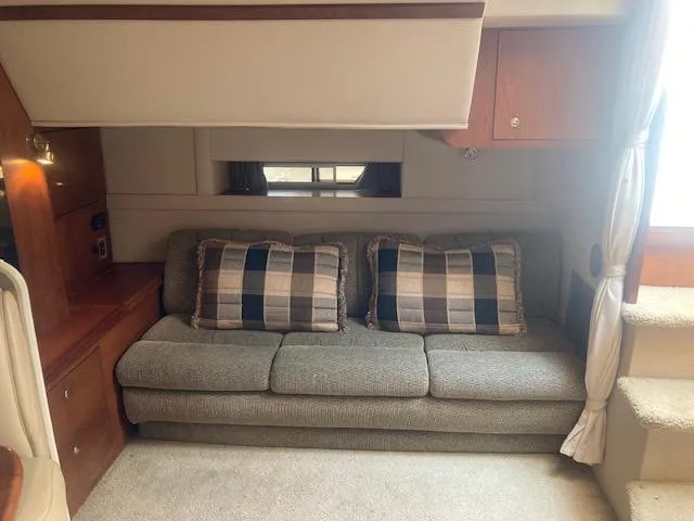 Slide: The Image of Interior of 2000 Cruisers Yachts 3575 Express with sofa and plaid cushions. - 15