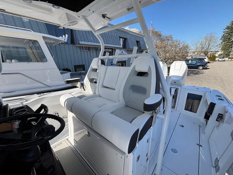Slide: The Image of 2025 Blackfin 332 CC boat interior with white seating and modern design. - 11