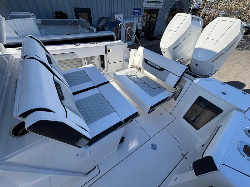 Slide: The Image of 2025 Blackfin 332 CC boat interior with seating and dual Mercury outboard engines. - 15
