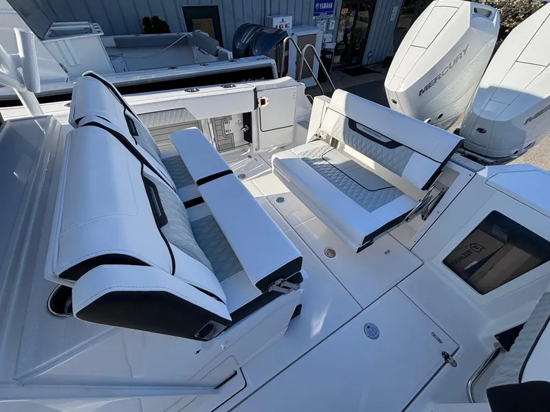 Slide: The Image of 2025 Blackfin 332 CC boat interior with spacious seating and dual Mercury engines. - 16