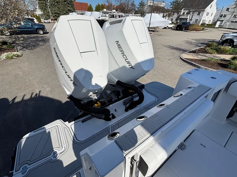 Slide: The Image of 2025 Blackfin 332 CC boat with dual Mercury outboard engines in a marina setting. - 17