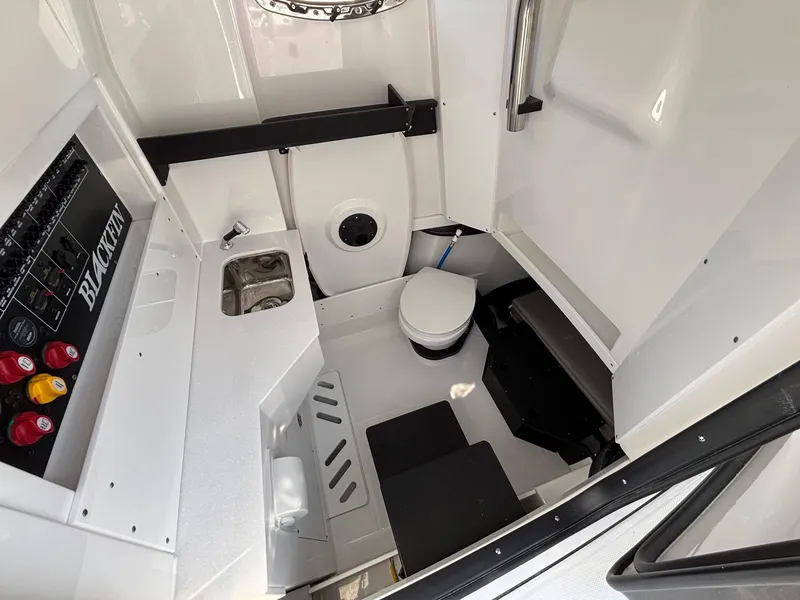Slide: The Image of 2025 Blackfin 332 CC boat interior with compact bathroom and sink. - 18