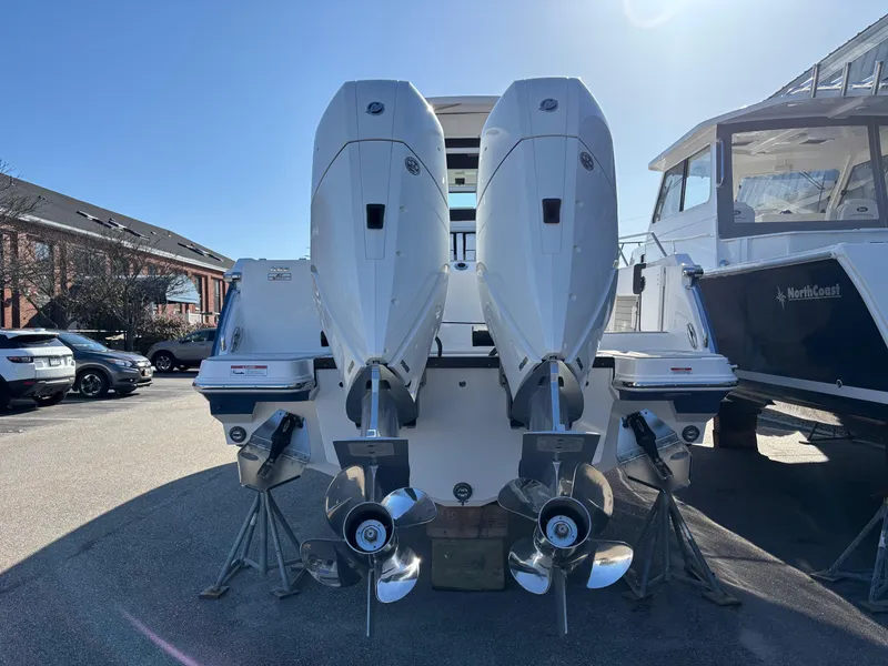 Slide: The Image of 2025 Blackfin 332 CC boat with dual outboard engines, displayed outdoors. - 3