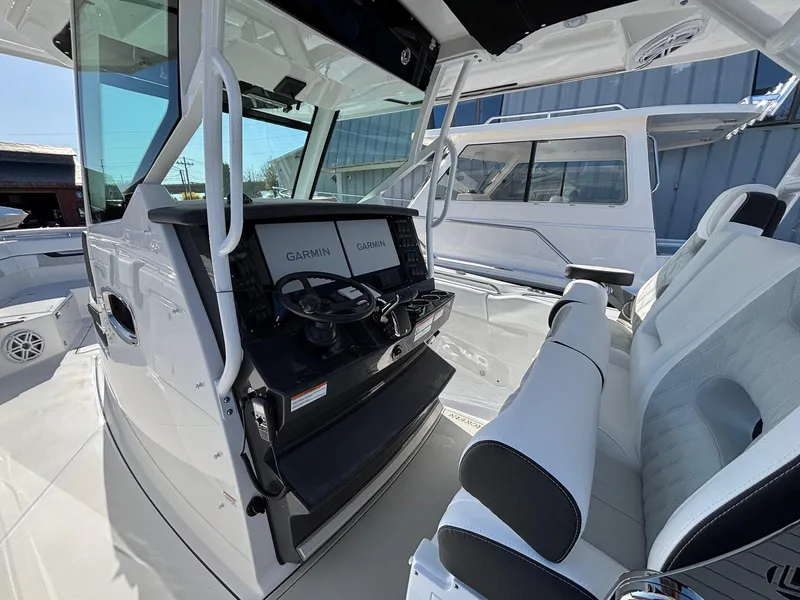 Slide: The Image of 2025 Blackfin 332 CC boat interior with Garmin navigation system and sleek seating. - 8