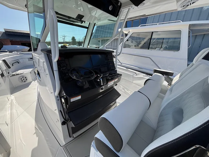 Slide: The Image of 2025 Blackfin 332 CC boat interior with modern helm and seating. - 9