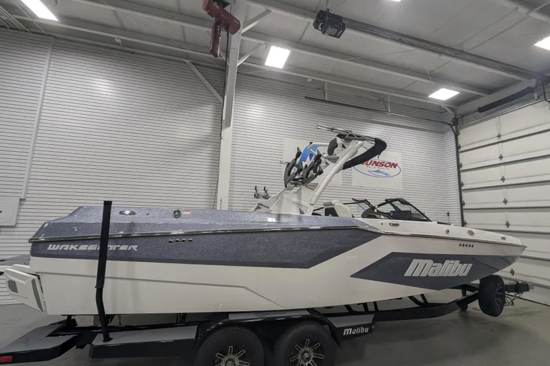 The Image of 2025 Malibu Wakesetter 24 MXZ boat in a garage, side view. - 0
