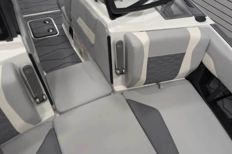 Slide: The Image of 2025 Malibu Wakesetter 24 MXZ interior seating, featuring sleek gray and white upholstery design. - 12