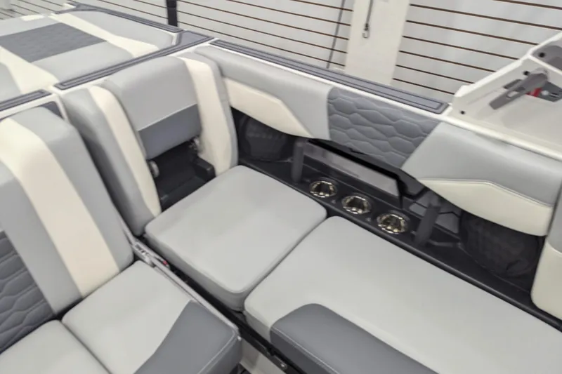 Slide: The Image of 2025 Malibu Wakesetter 24 MXZ interior with gray and white seating, modern design. - 16