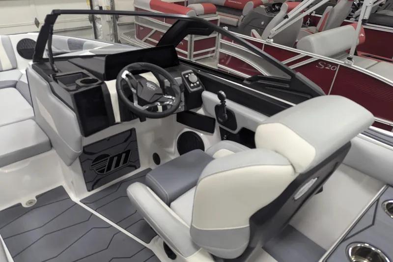 Slide: The Image of 2025 Malibu Wakesetter 24 MXZ boat interior with modern steering and seating. - 21