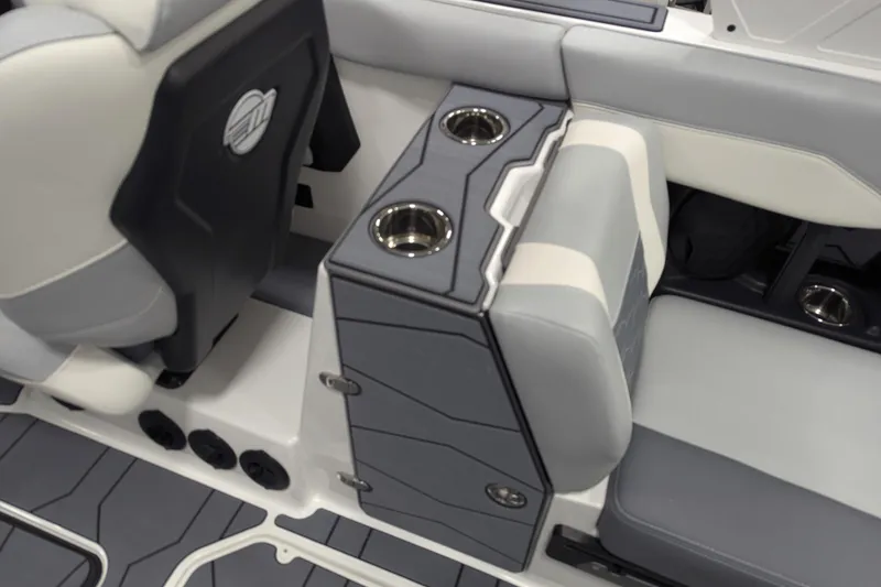 Slide: The Image of 2025 Malibu Wakesetter 24 MXZ interior with gray seating and cup holders. - 22