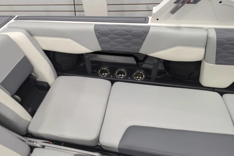 Slide: The Image of 2025 Malibu Wakesetter 24 MXZ interior seating with gray and white upholstery. - 26