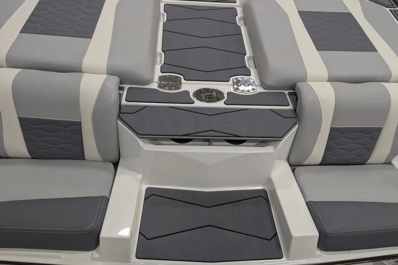 Slide: The Image of 2025 Malibu Wakesetter 24 MXZ boat interior with sleek gray and white seating design. - 28