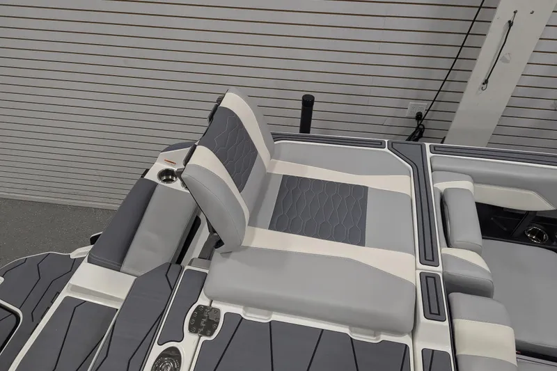 Slide: The Image of 2025 Malibu Wakesetter 24 MXZ boat interior with gray and white seating. - 29