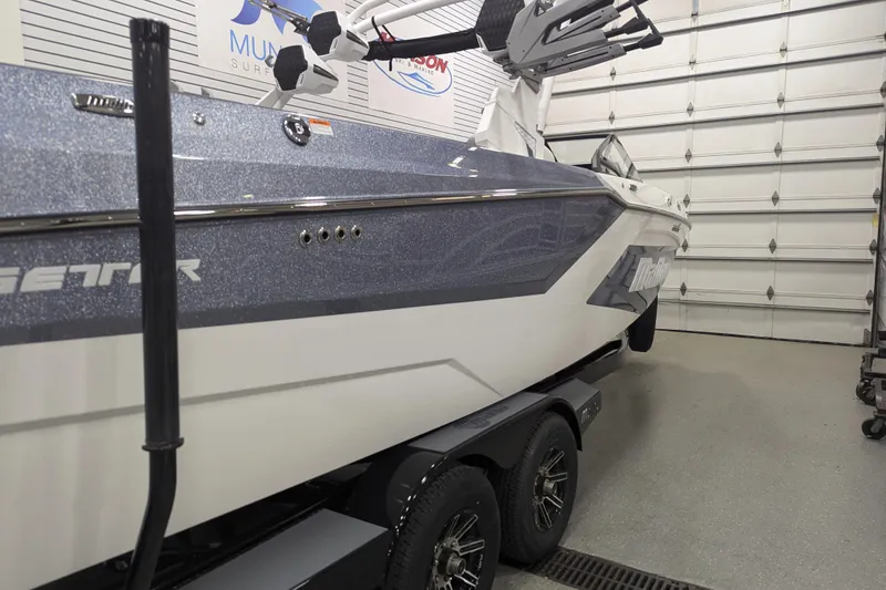 Slide: The Image of 2025 Malibu Wakesetter 24 MXZ boat in garage, side view, on trailer. - 3