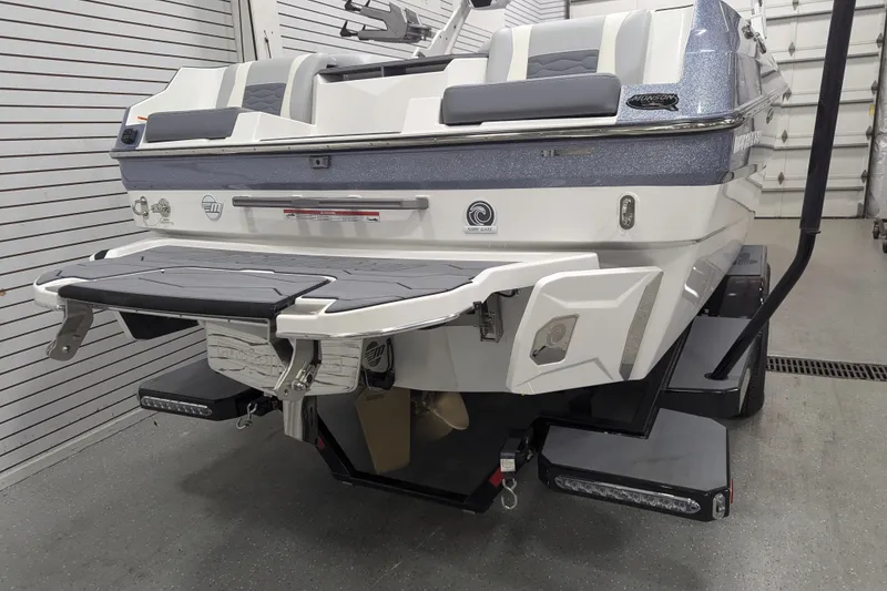 Slide: The Image of 2025 Malibu Wakesetter 24 MXZ boat rear view in a garage setting. - 4