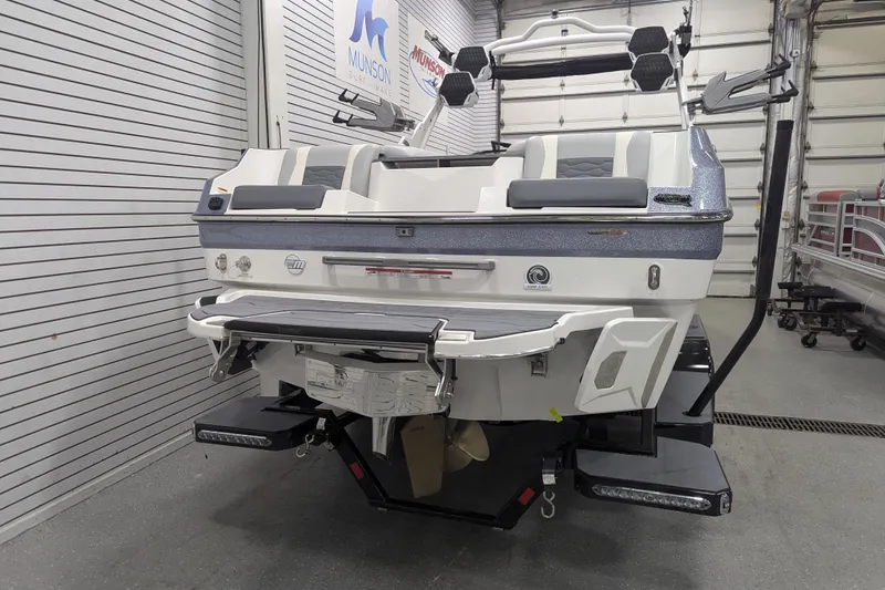 Slide: The Image of 2025 Malibu Wakesetter 24 MXZ boat in showroom, rear view with swim platform. - 7