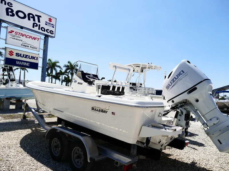 The Image of 2025 Bulls Bay 2000 boat on trailer, palm trees in background, sunny day. - 0