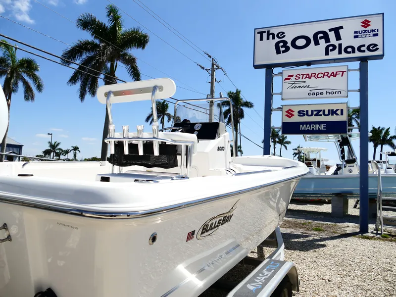Slide: The Image of 2025 Bulls Bay 2000 boat with Suzuki engine on trailer at dealership. - 2