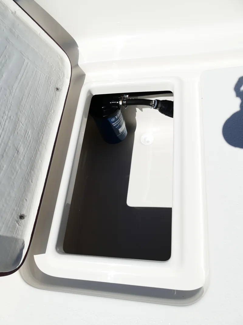 Slide: The Image of 2025 Bulls Bay 2000 boat with Suzuki outboard motor, parked on gravel. - 29