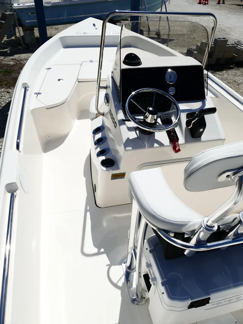 Slide: The Image of 2025 Bulls Bay 2000 boat displayed outdoors with Suzuki engine, palm trees, and dealership signs. - 5