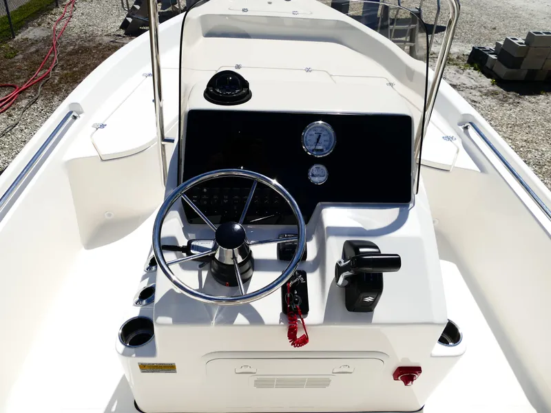 Slide: The Image of 2025 Bulls Bay 2000 boat at dealership with palm trees and signage in background. - 7