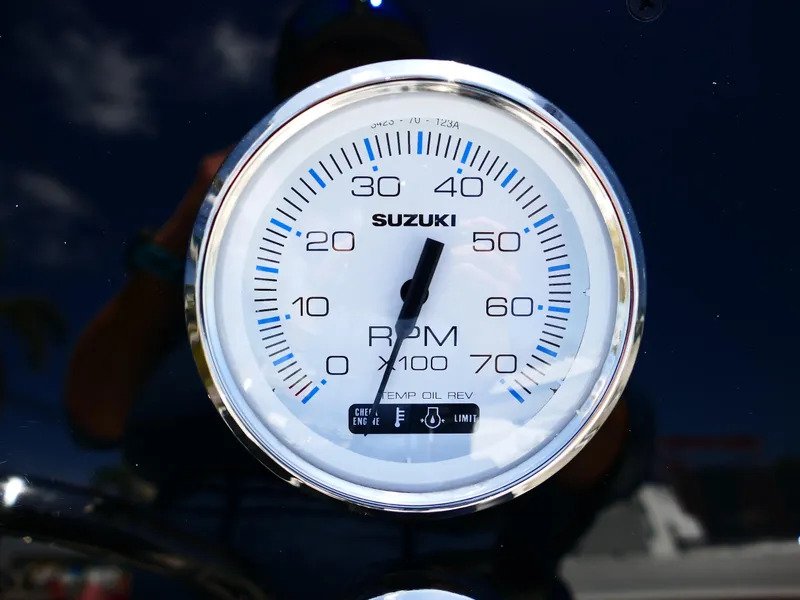 Slide: The Image of Bulls Bay 2000 boat at dealership, clear sky, palm trees, and signage in background. - 9