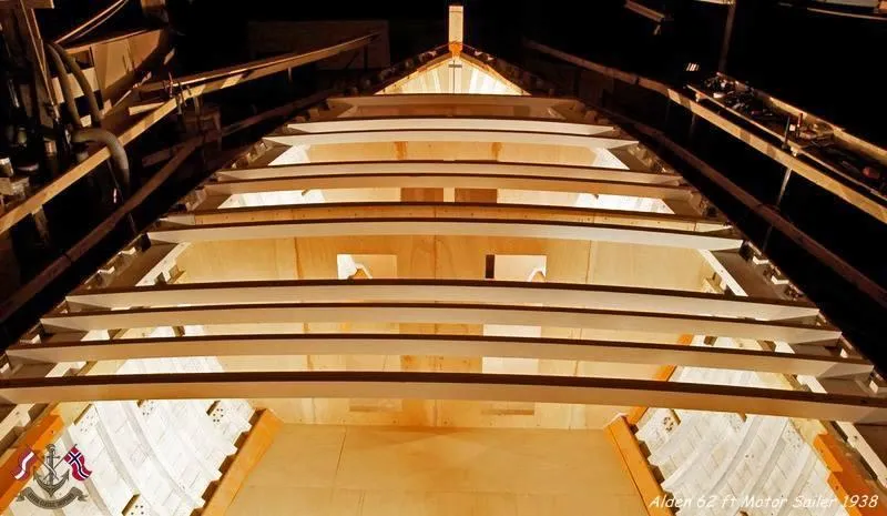 Slide: The Image of Alden 62' yacht interior under construction, showcasing wooden framework and beams, 1938 design. - 10