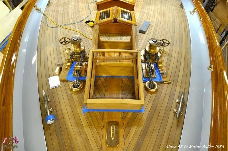 Slide: The Image of Alden 1938 motor sailer deck with wooden finish and brass fittings, custom design by Rockport Marine. - 13