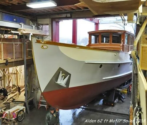 Slide: The Image of Alden 62 ft motor sailer, 1938, in a boatyard, showcasing classic design and craftsmanship. - 14
