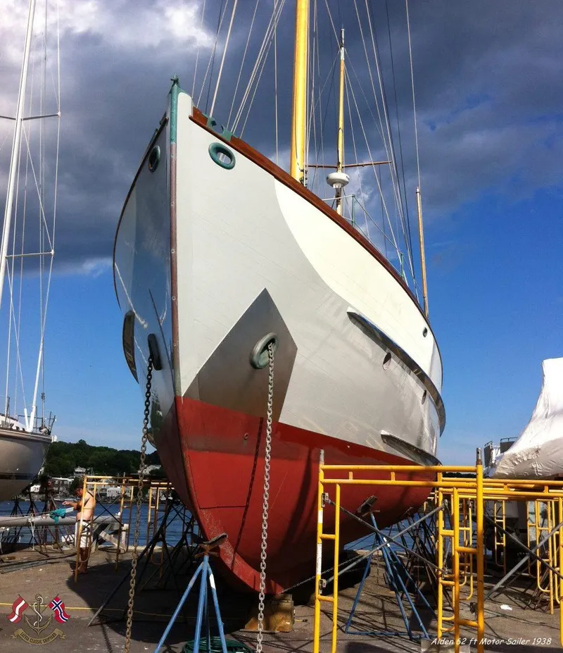 Slide: The Image of Alden custom-designed boat, 1938, in dry dock, with vibrant red and white hull. - 15