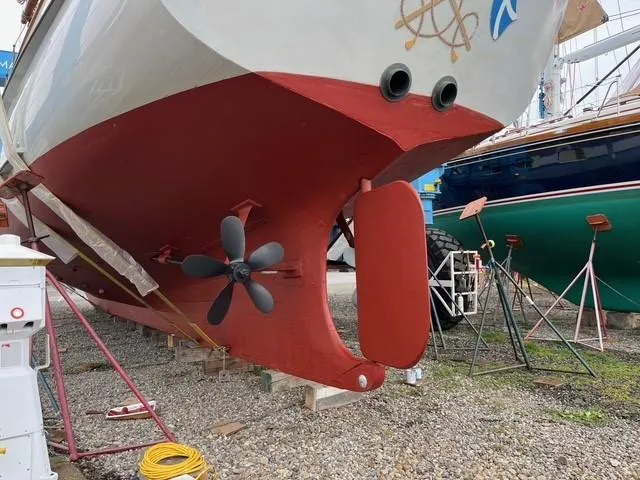 Slide: The Image of Alden custom-designed boat, 1938, with red hull and propeller, in dry dock at Rockport Marine. - 17