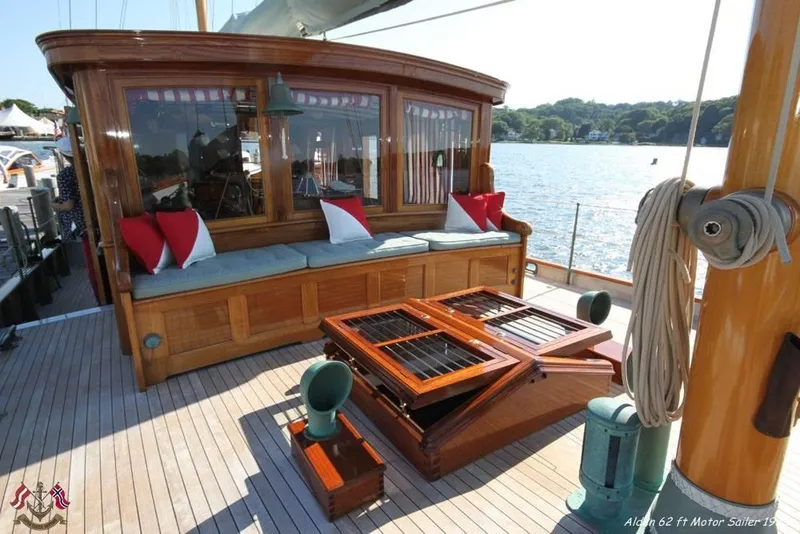 Slide: The Image of Luxurious 1938 Alden yacht deck with elegant seating and scenic water view. - 29