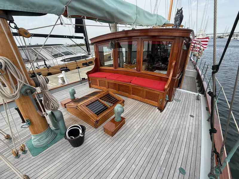 Slide: The Image of Vintage 1938 Alden yacht deck with wooden cabin, red seating, and nautical details. - 30