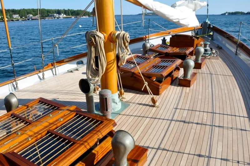 Slide: The Image of Deck of 1938 Alden custom sailboat by Rockport Marine, featuring polished wood and nautical details. - 36