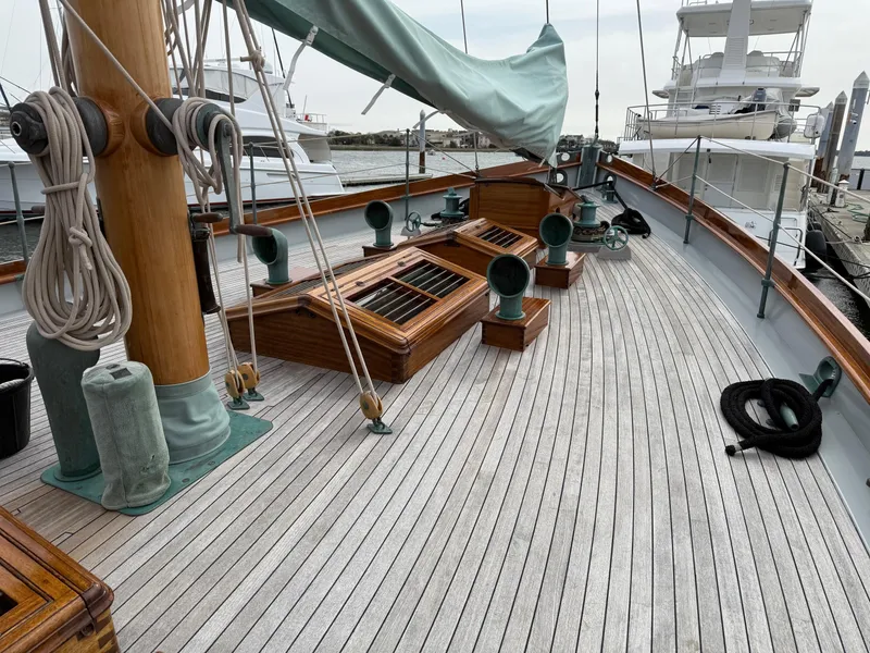 Slide: The Image of Deck of 1938 Alden sailboat, custom design by Rockport Marine, featuring wooden details and rigging. - 37