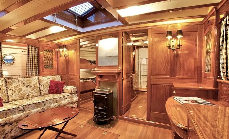 Slide: The Image of Luxurious wooden interior of a 1938 Alden yacht, featuring elegant furnishings and warm lighting. - 4
