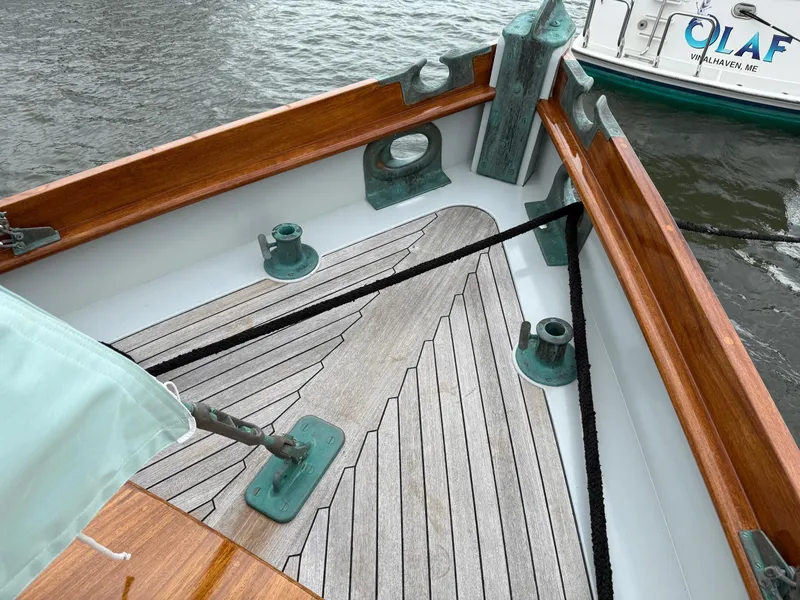 Slide: The Image of Wooden deck of 1938 Alden boat, custom design by Rockport Marine, docked on water. - 40
