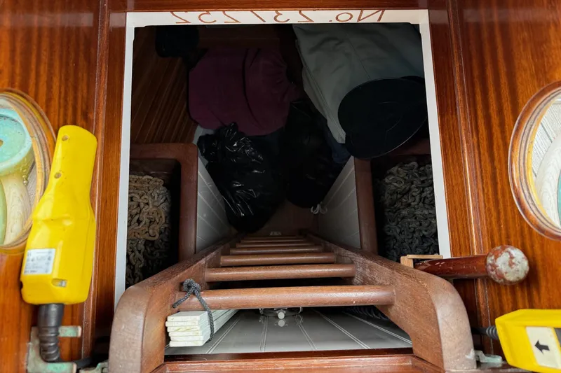 Slide: The Image of Wooden ladder leading to storage area inside 1938 Alden custom-designed boat by Rockport Marine. - 43