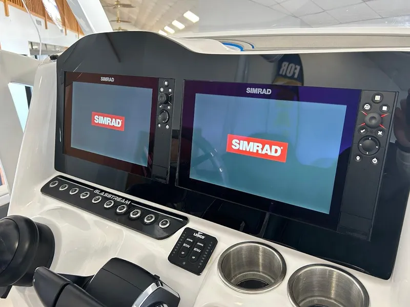 Slide: The Image of 2024 Glasstream 28 GSX Pro dashboard with dual Simrad displays. - 13