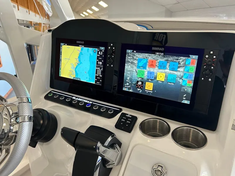 Slide: The Image of 2024 Glasstream 28 GSX Pro dashboard with dual Simrad displays and modern controls. - 14